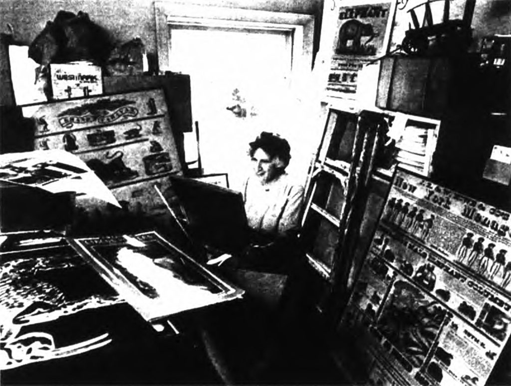 Mabel Addis surrounded by art in a back room of a museum